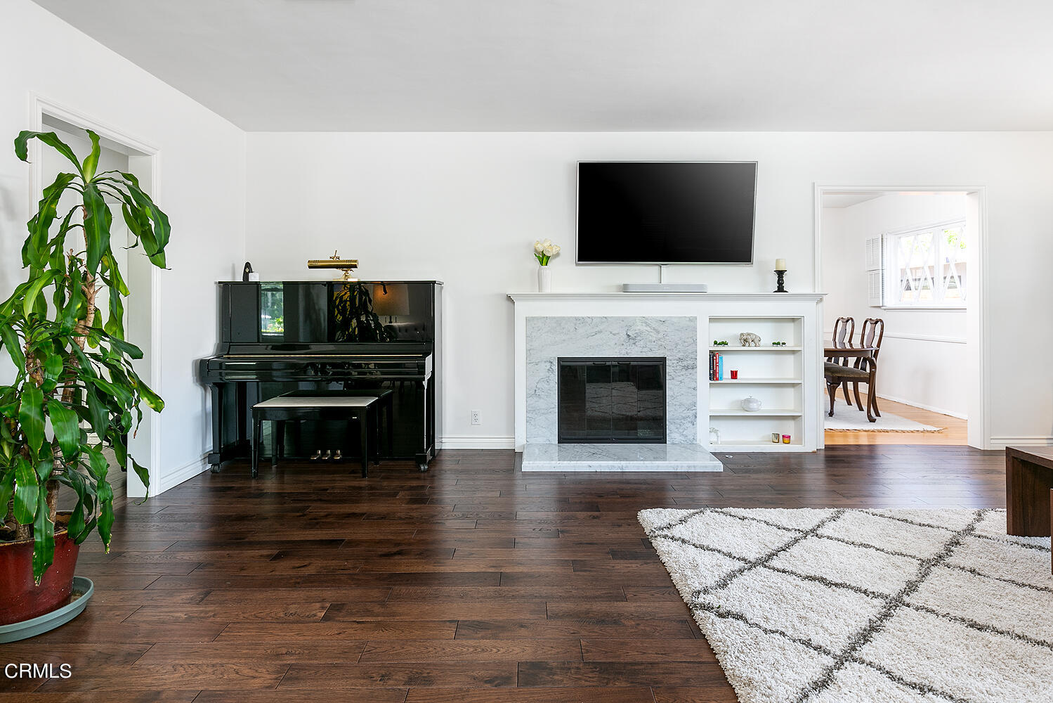 2375 East Woodlyn Road Pasadena, CA 91104 - Photo 10 of 33 a living room with furniture a flat screen tv and a fireplace
