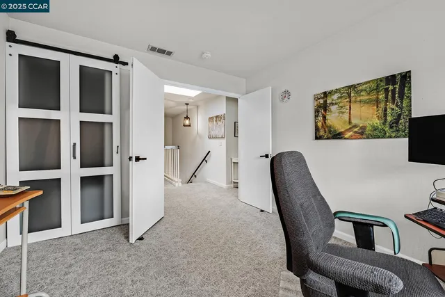 a view of a workspace with furniture and entryway