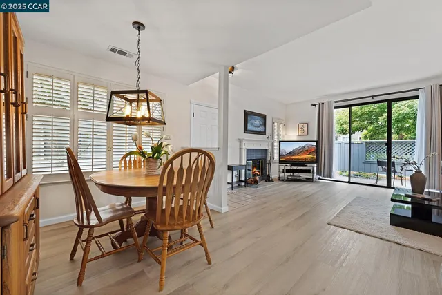 a view of a livingroom with furniture window and wooden floor