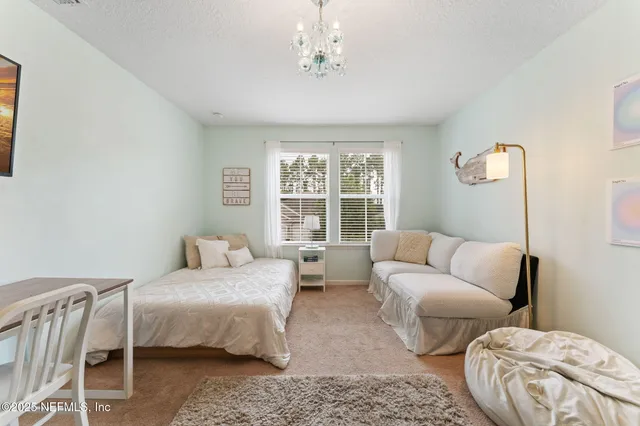 a bedroom with furniture and a large window