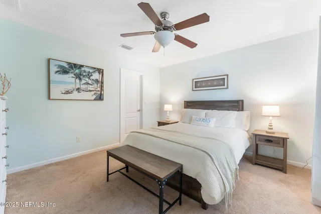 a bedroom with a bed and a painting on the wall