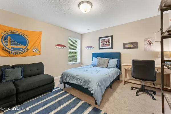 a bedroom with a bed and a couch