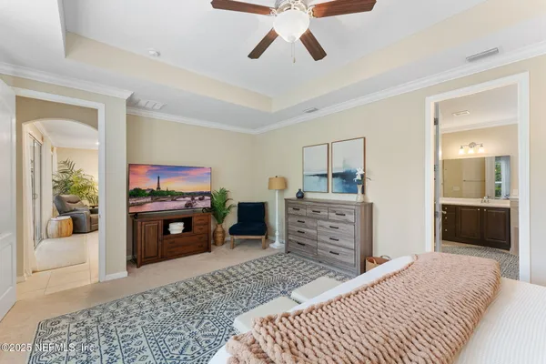 a bedroom with a bed and a television