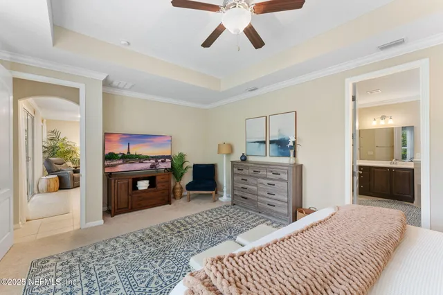 a bedroom with a bed and a television