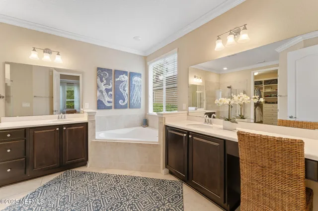 a spacious bathroom with a bathtub sink and mirror