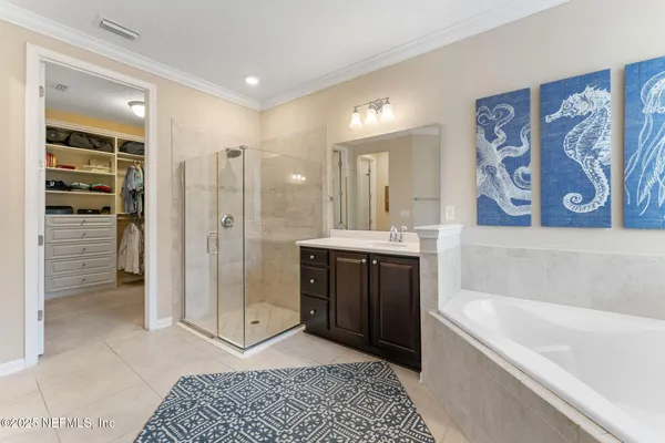 a bathroom with a tub a sink and shower