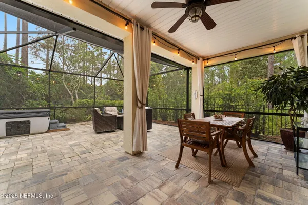 a dining room with furniture and a floor to ceiling window