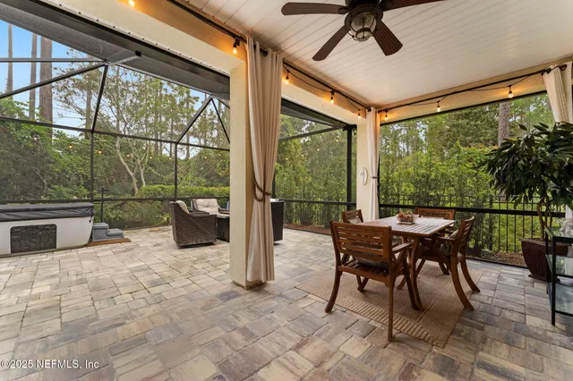 a dining room with furniture and a floor to ceiling window