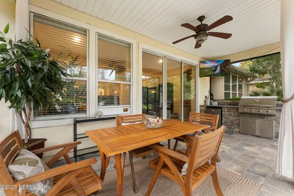 a dining room with furniture a chandelier and wooden floor