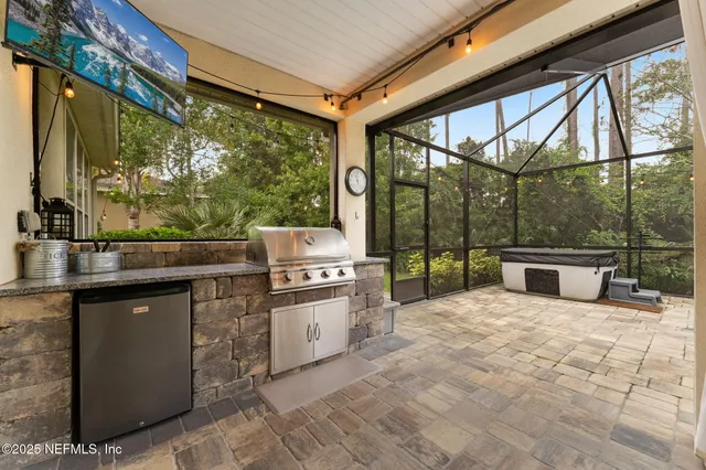 a view of a patio with a table chairs and a floor to ceiling window