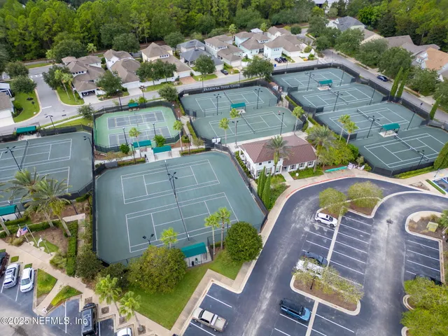 an aerial view of a house with a swimming pool a yard and a patio