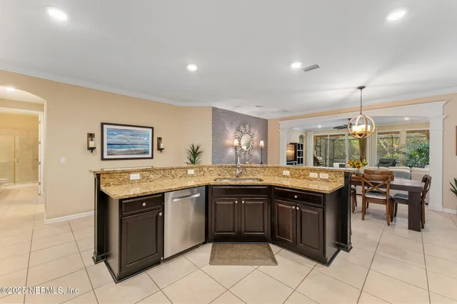 a large kitchen with kitchen island a sink table and chairs