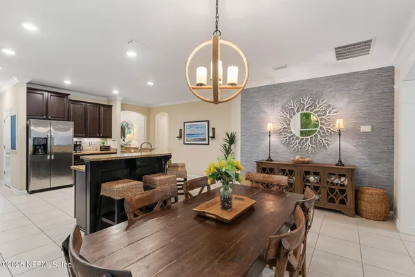 a room with stainless steel appliances kitchen island granite countertop furniture and a view of kitchen