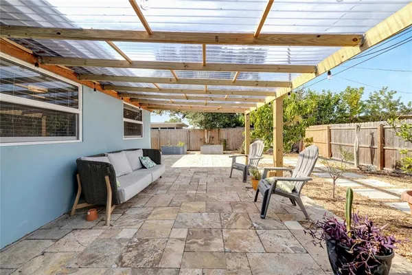 a view of a chair and table in the backyard