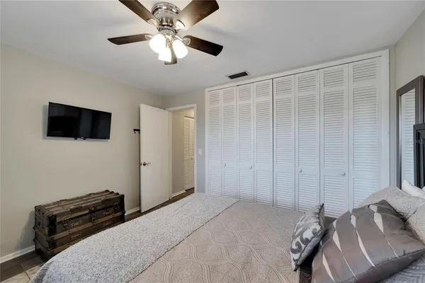 a bedroom with a bed and a flat screen tv