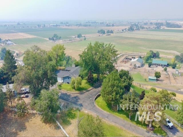1549 Cove Road Weiser, ID 83672 - Photo 36 of 38 Aerial landscape featuring a residential property with a winding driveway, extensive green space, and mature trees