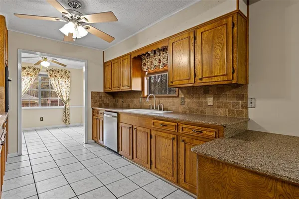 a large kitchen with stainless steel appliances granite countertop a sink and cabinets