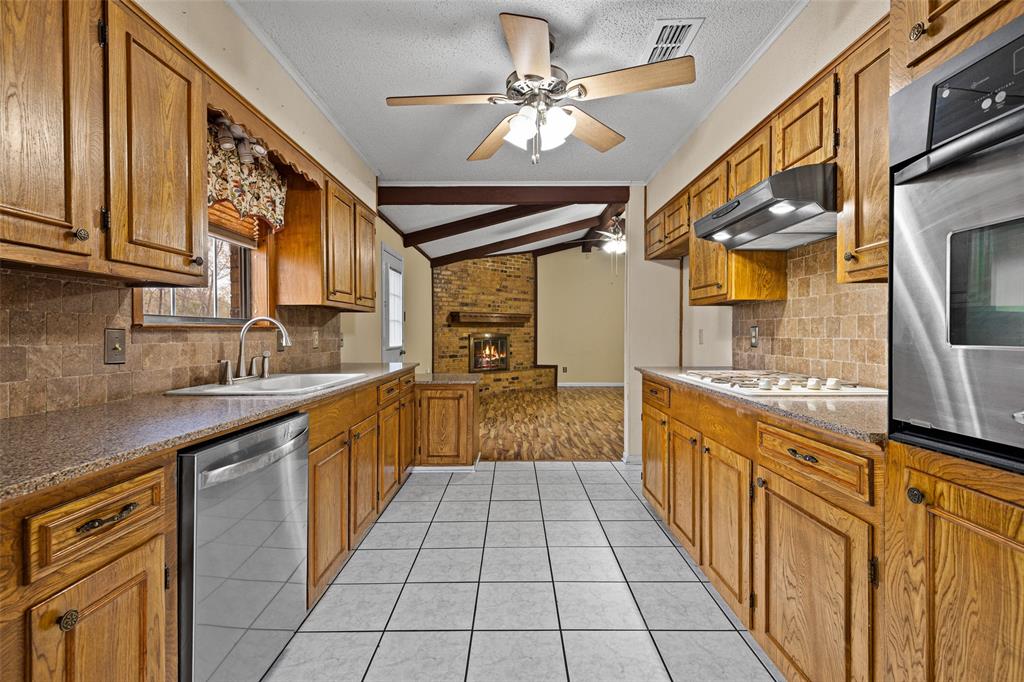 3215 Restview Street Longview, TX 75605 - Photo 16 of 40 a large kitchen with stainless steel appliances granite countertop a sink and cabinets