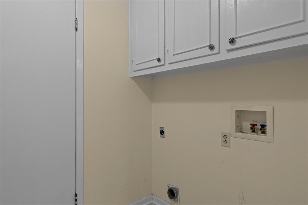 3215 Restview Street Longview, TX 75605 - Photo 19 of 40 a view of cabinets and dryer