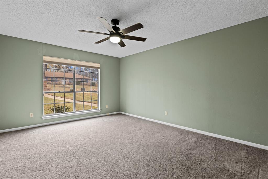 3215 Restview Street Longview, TX 75605 - Photo 21 of 40 an empty room with a window and a fan