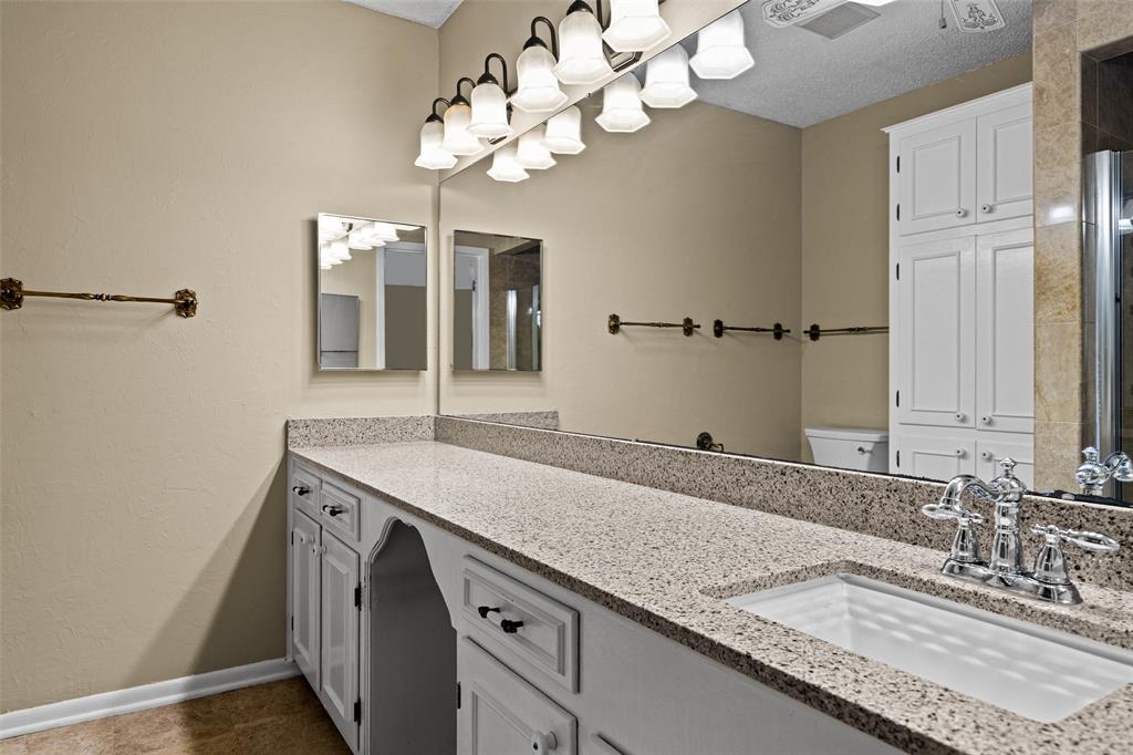 3215 Restview Street Longview, TX 75605 - Photo 31 of 40 a bathroom with a granite countertop double vanity and a mirror