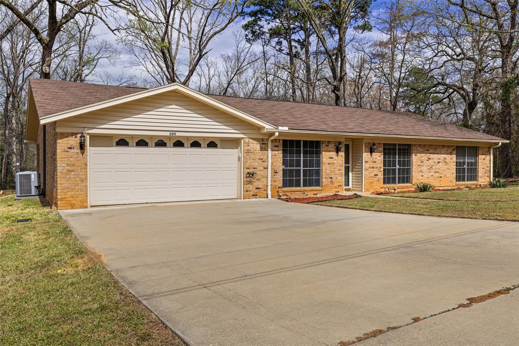 3215 Restview Street Longview, TX 75605 - Photo 4 of 40 a front view of a house with a yard and garage