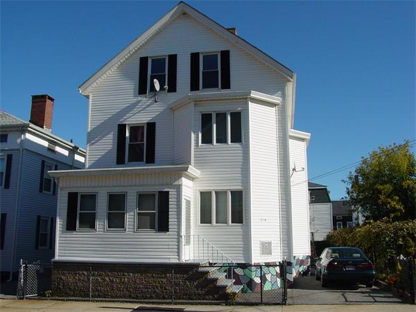 210 4th Street Fall River, MA 02721 - Photo 1 of 27 a front view of a house with a yard