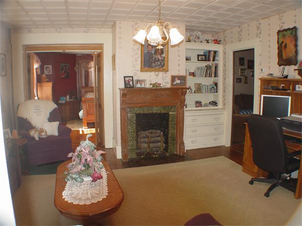 210 4th Street Fall River, MA 02721 - Photo 16 of 27 a living room with furniture a fireplace and a chandelier