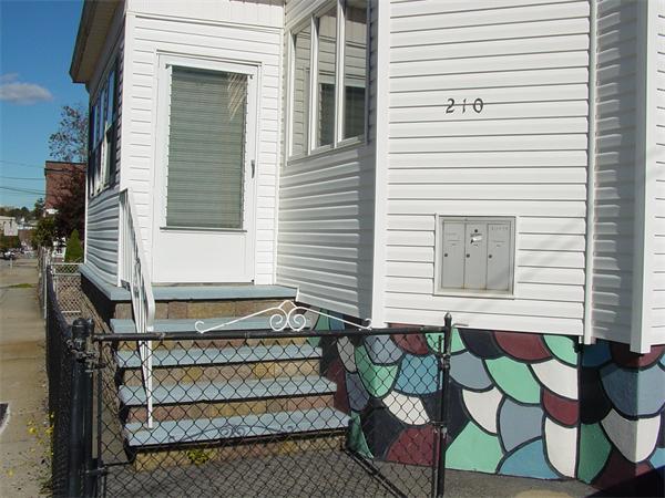 210 4th Street Fall River, MA 02721 - Photo 3 of 27 a front view of a house with a garage