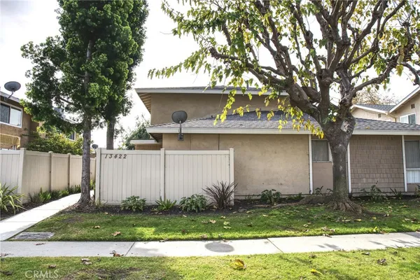 a house that has a tree in front of it
