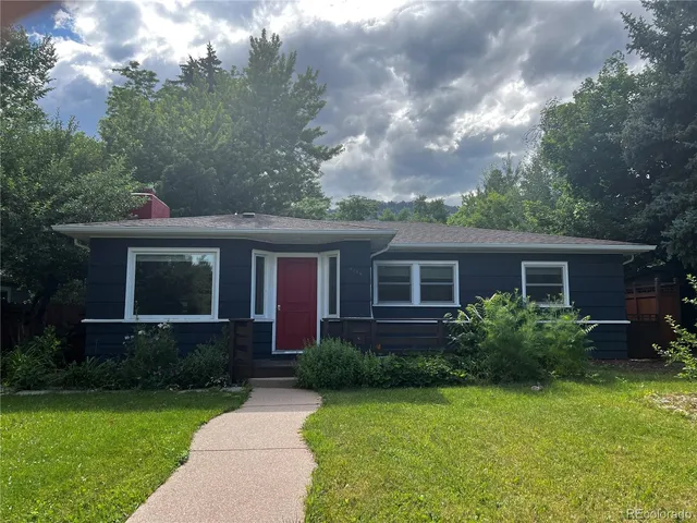 a front view of house with yard and green space