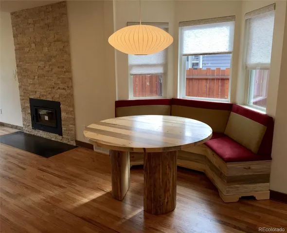 a living room with furniture a table and a fireplace