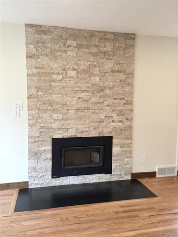 a room with a fireplace and a wooden floor