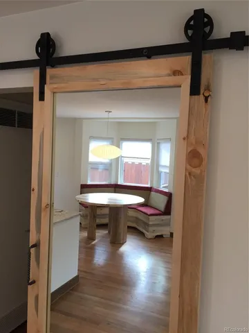 a room with pool table wooden floor and a window