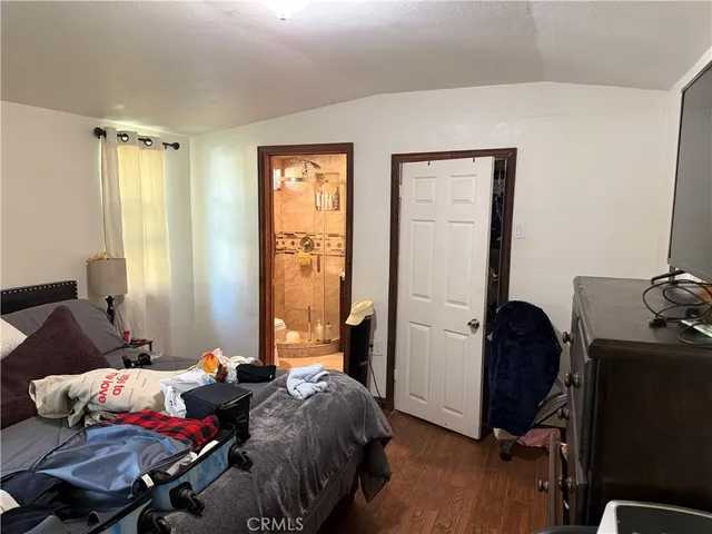 a bedroom with bed and a window