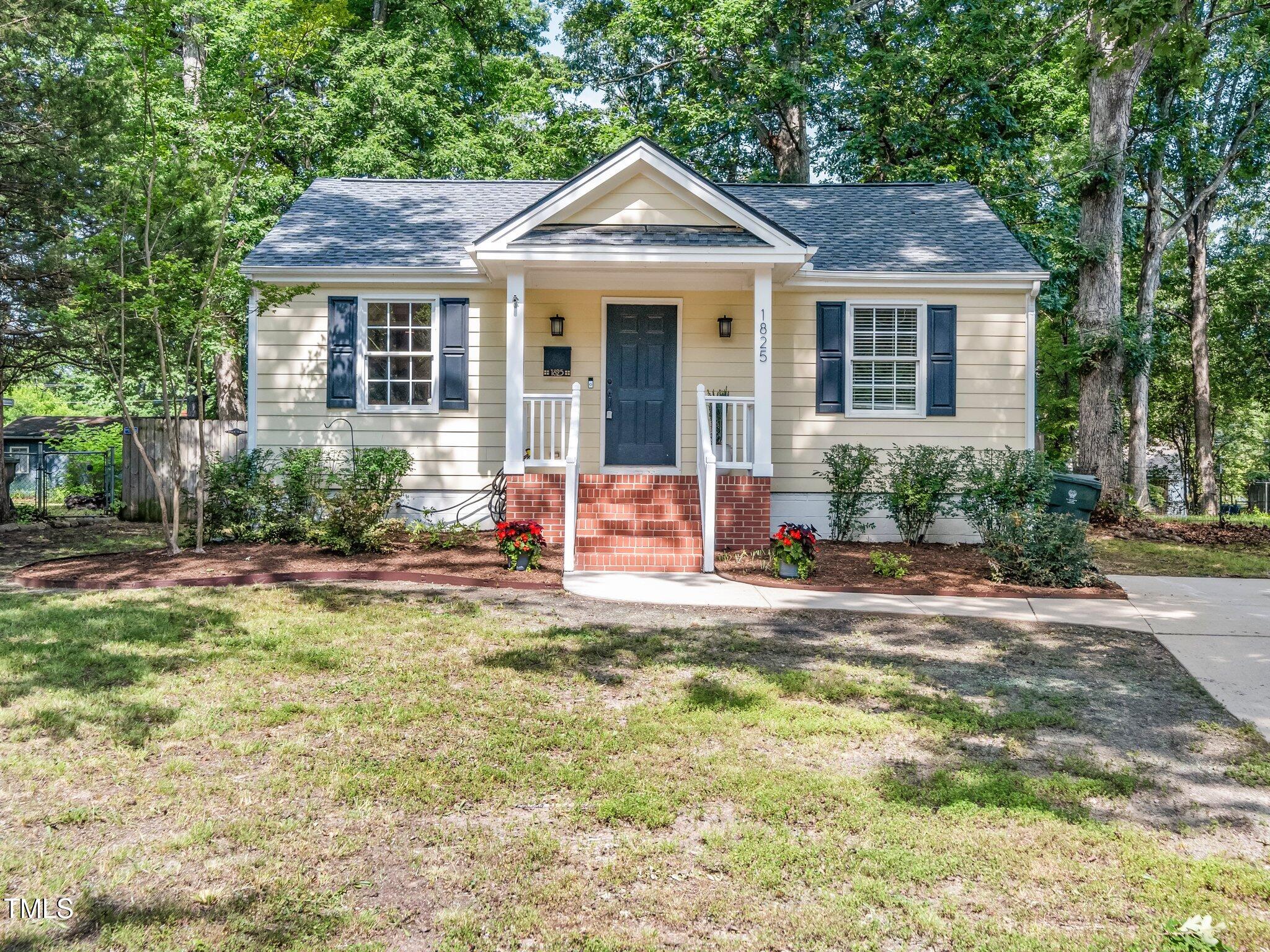 1825 Watkins Street Raleigh, NC 27604 - Photo 1 of 27 a front view of a house with yard porch and furniture