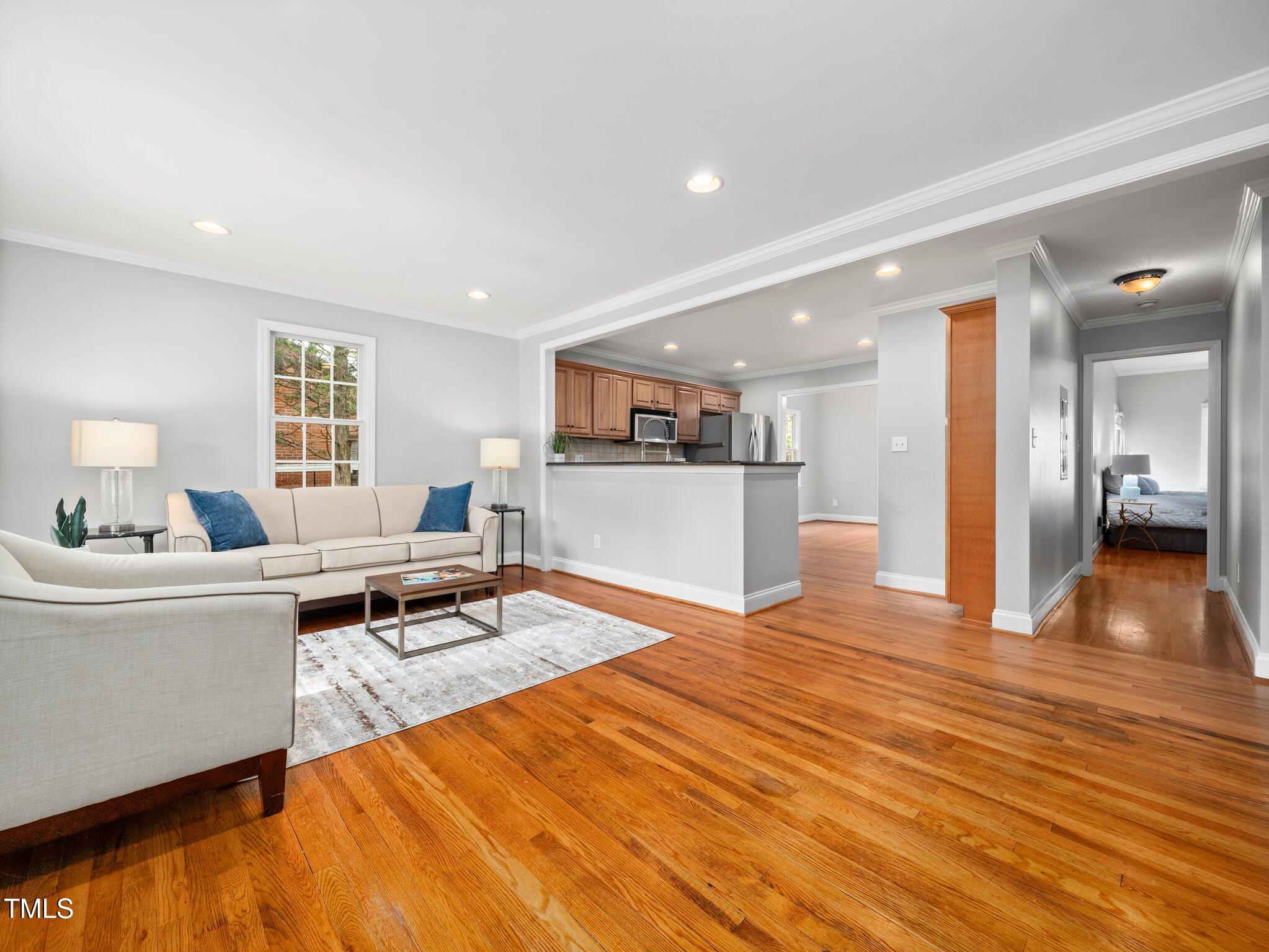 1825 Watkins Street Raleigh, NC 27604 - Photo 3 of 27 a living room with furniture and a wooden floor