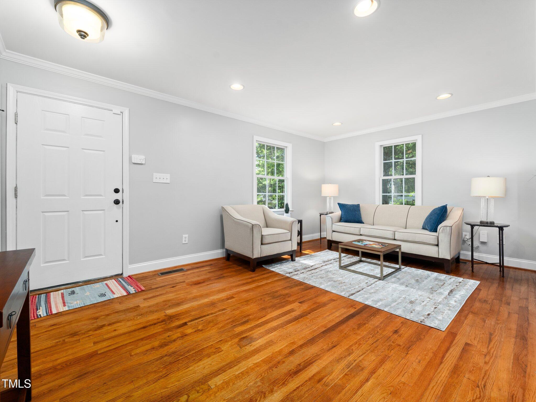 1825 Watkins Street Raleigh, NC 27604 - Photo 4 of 27 a living room with furniture and a wooden floor