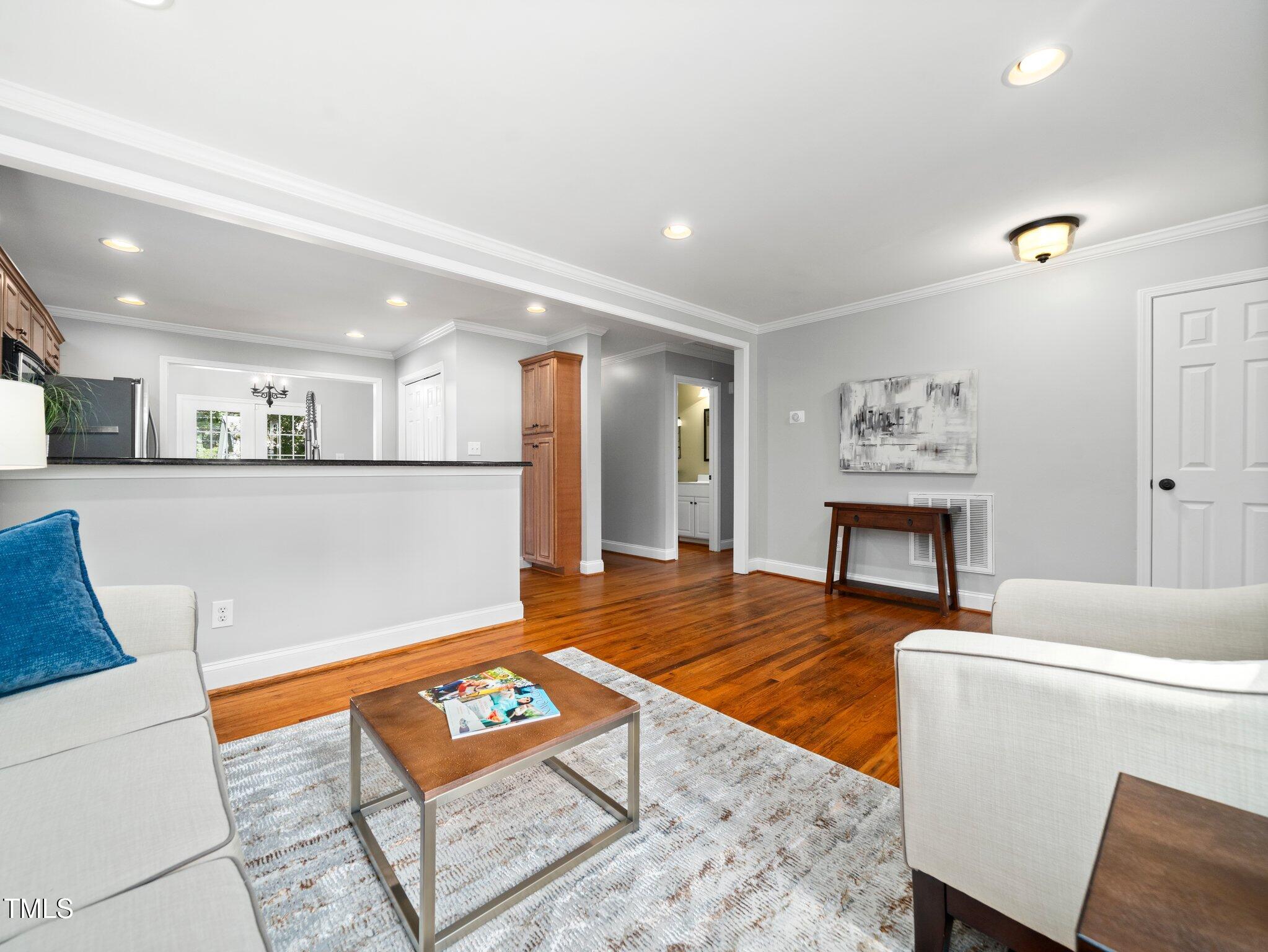 1825 Watkins Street Raleigh, NC 27604 - Photo 6 of 27 a living room with furniture and a table with wooden floor