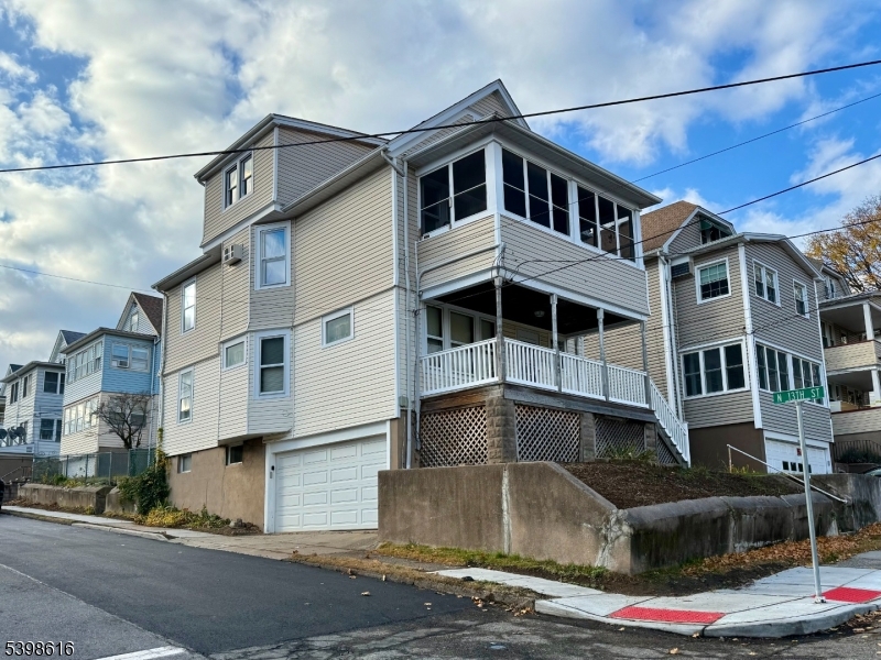a front view of a house with a street