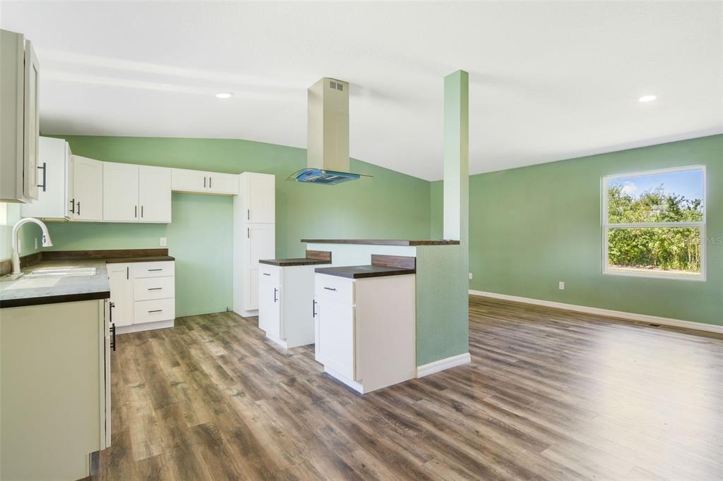 3380 Maple Lane Haines City, FL 33844 - Photo 13 of 28 a kitchen with a sink cabinets and wooden floor