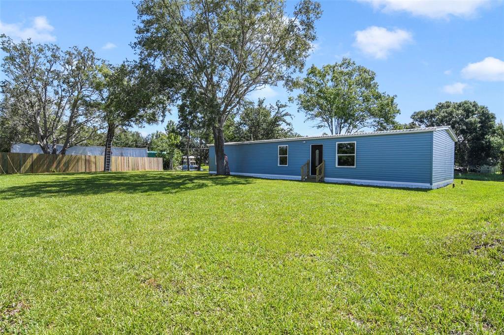 3380 Maple Lane Haines City, FL 33844 - Photo 25 of 28 a view of a house with backyard and trees
