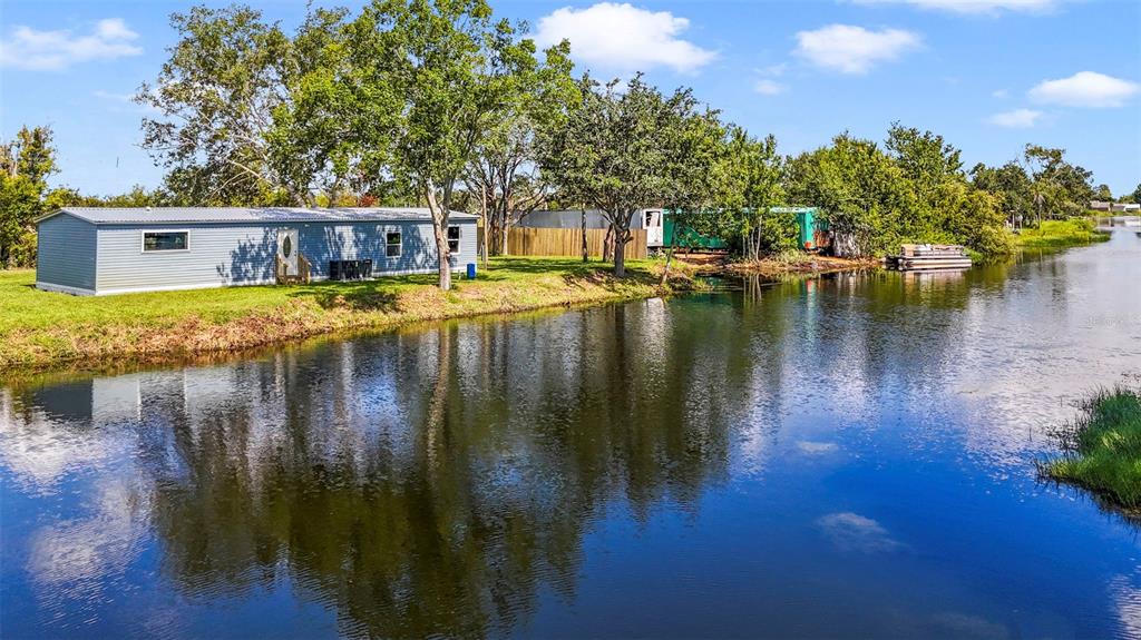 3380 Maple Lane Haines City, FL 33844 - Photo 27 of 28 a view of a lake with a house in the background