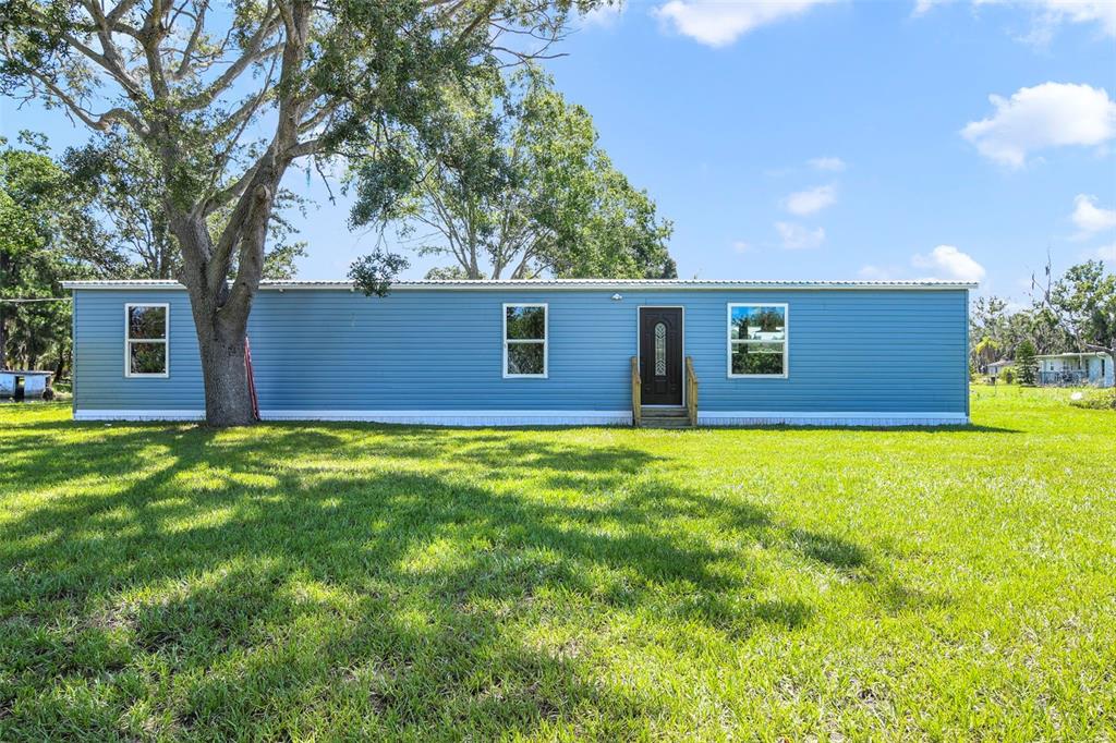 3380 Maple Lane Haines City, FL 33844 - Photo 4 of 28 a front view of house with yard and trees