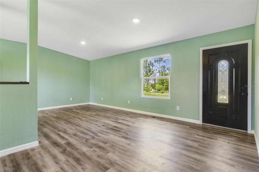 3380 Maple Lane Haines City, FL 33844 - Photo 6 of 28 wooden floor in an empty room with a window