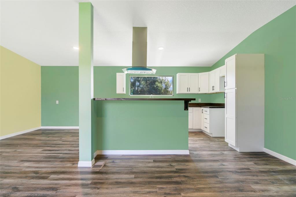 3380 Maple Lane Haines City, FL 33844 - Photo 8 of 28 a view of a kitchen with wooden floor and a window