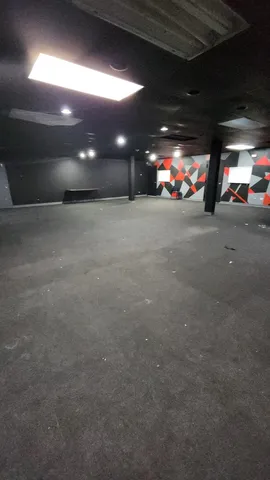 a view of an empty room with yellow lighting