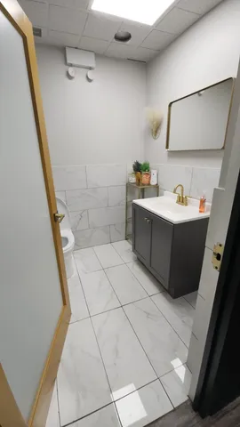 a bathroom with a bathtub sink and mirror