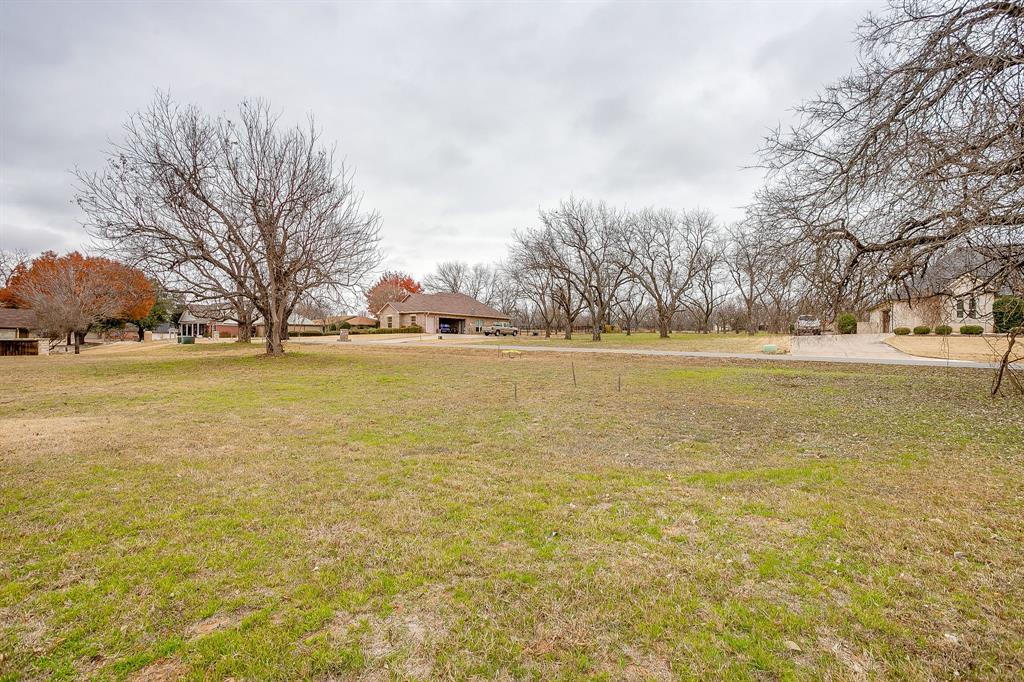 9314 Bellechase Road Granbury, TX 76049 - Photo 20 of 26 a view of an ocean with trees in the background