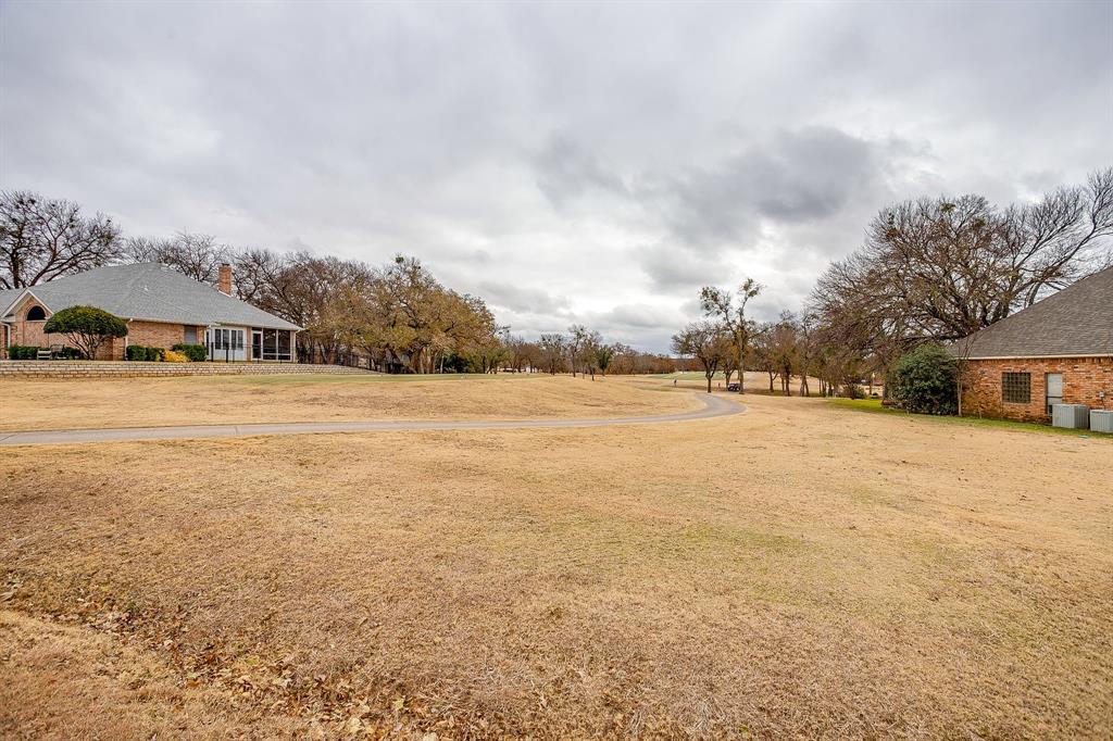 9314 Bellechase Road Granbury, TX 76049 - Photo 23 of 26 a view of road with large trees